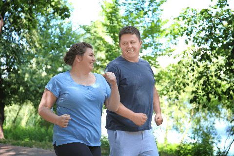 couple smiling walking in park